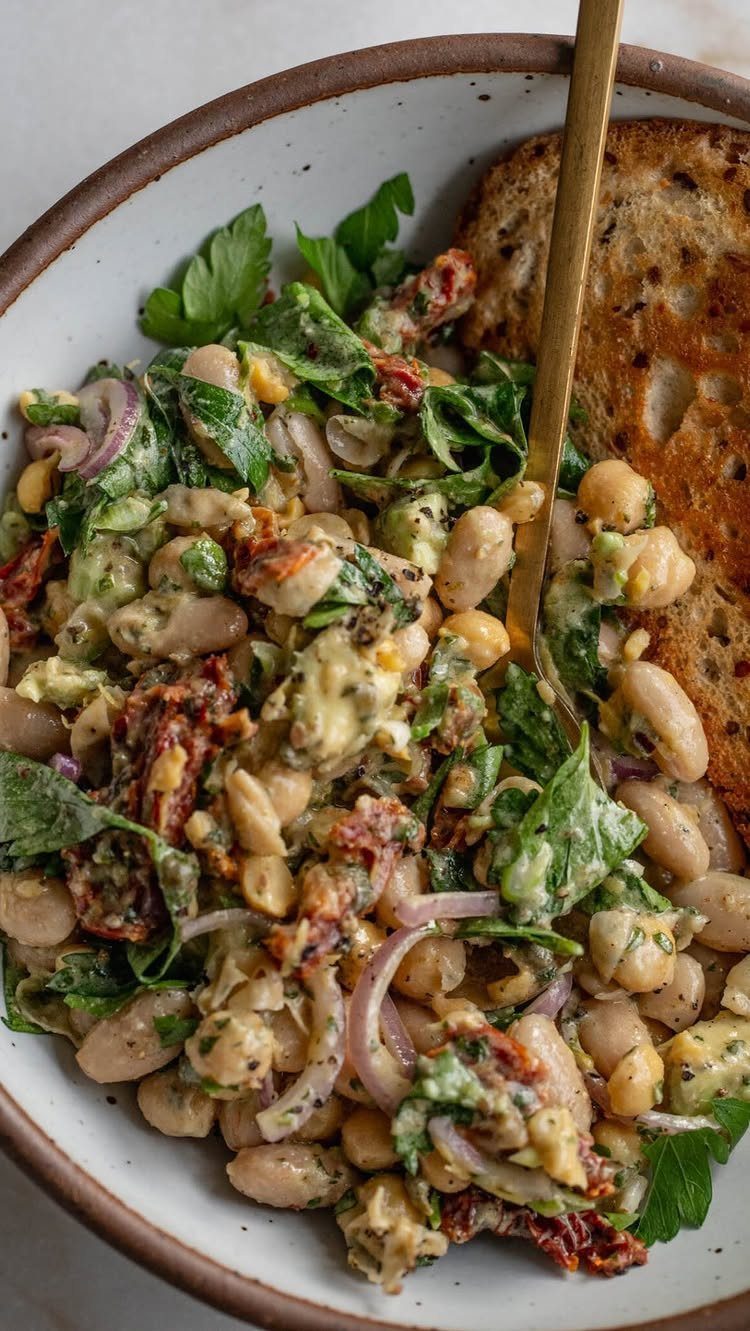 Cannellini bean salad with greens and sun-dried tomatoes served with toasted bread.
