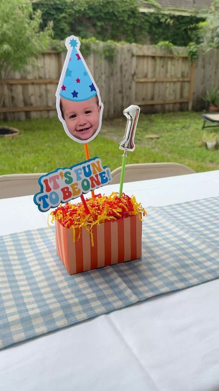 First birthday centerpiece with baby photo cutout and silver number one balloon
