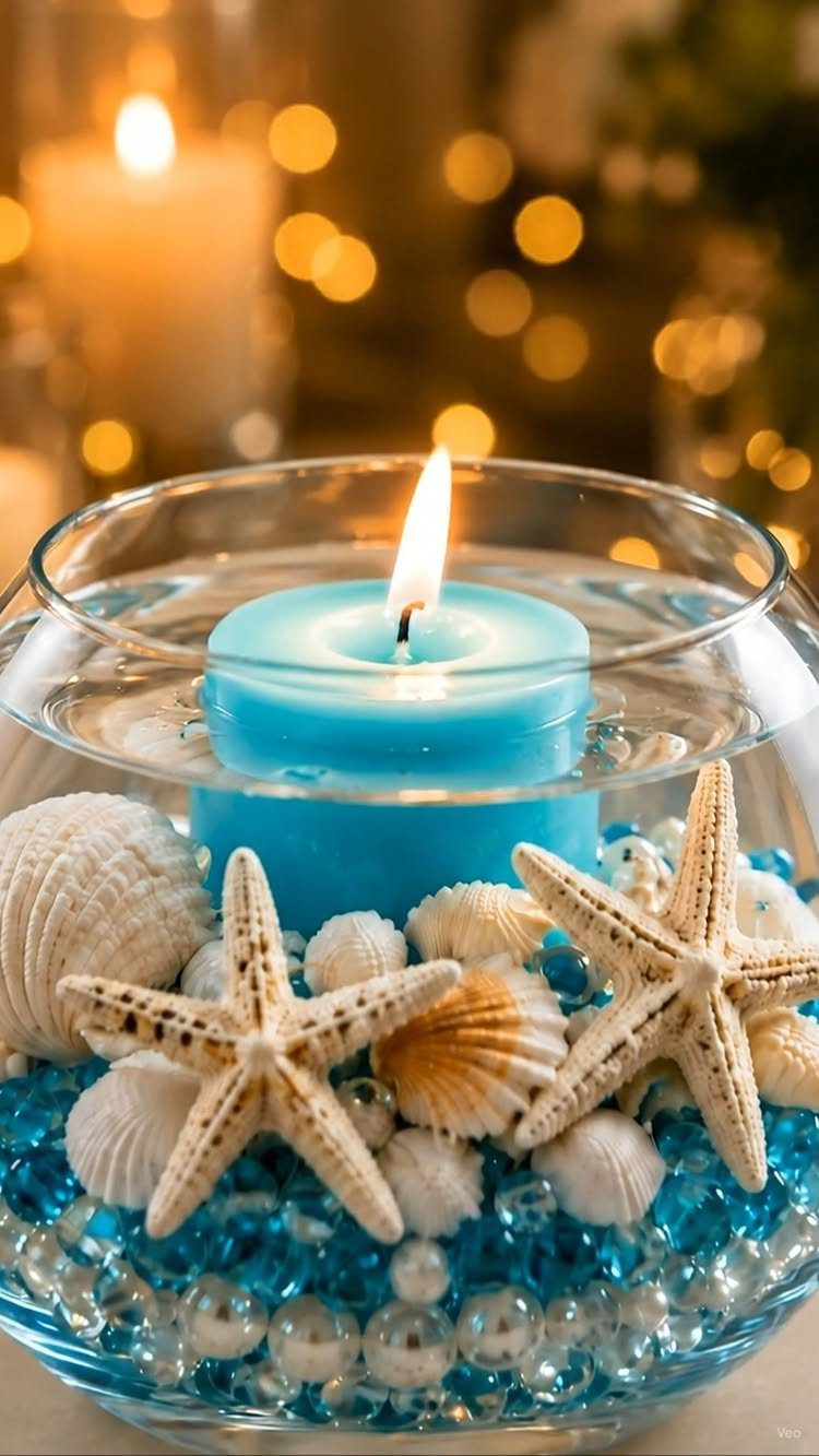 Blue floating candle in a glass bowl with starfish, seashells, and blue beads.