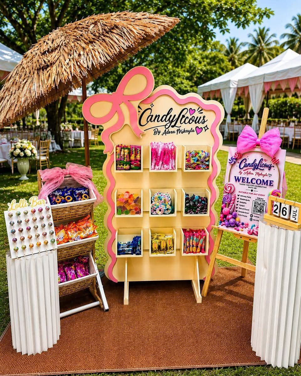 Candy station with a thatched tiki umbrella and colorful treats in yellow displays.