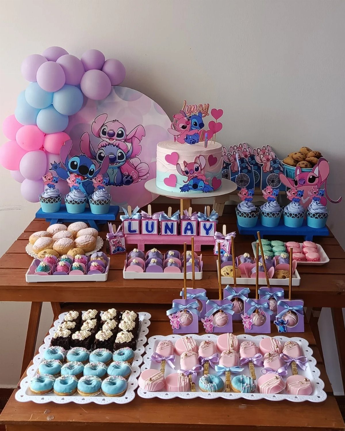 Lilo and Stitch themed candy table with blue and pink treats and balloons