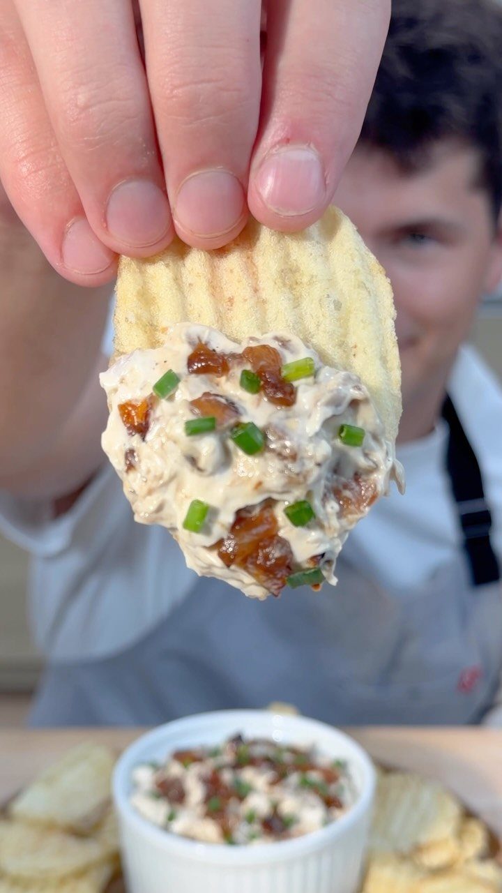 Ridged potato chip topped with creamy French onion dip and fresh green chives.