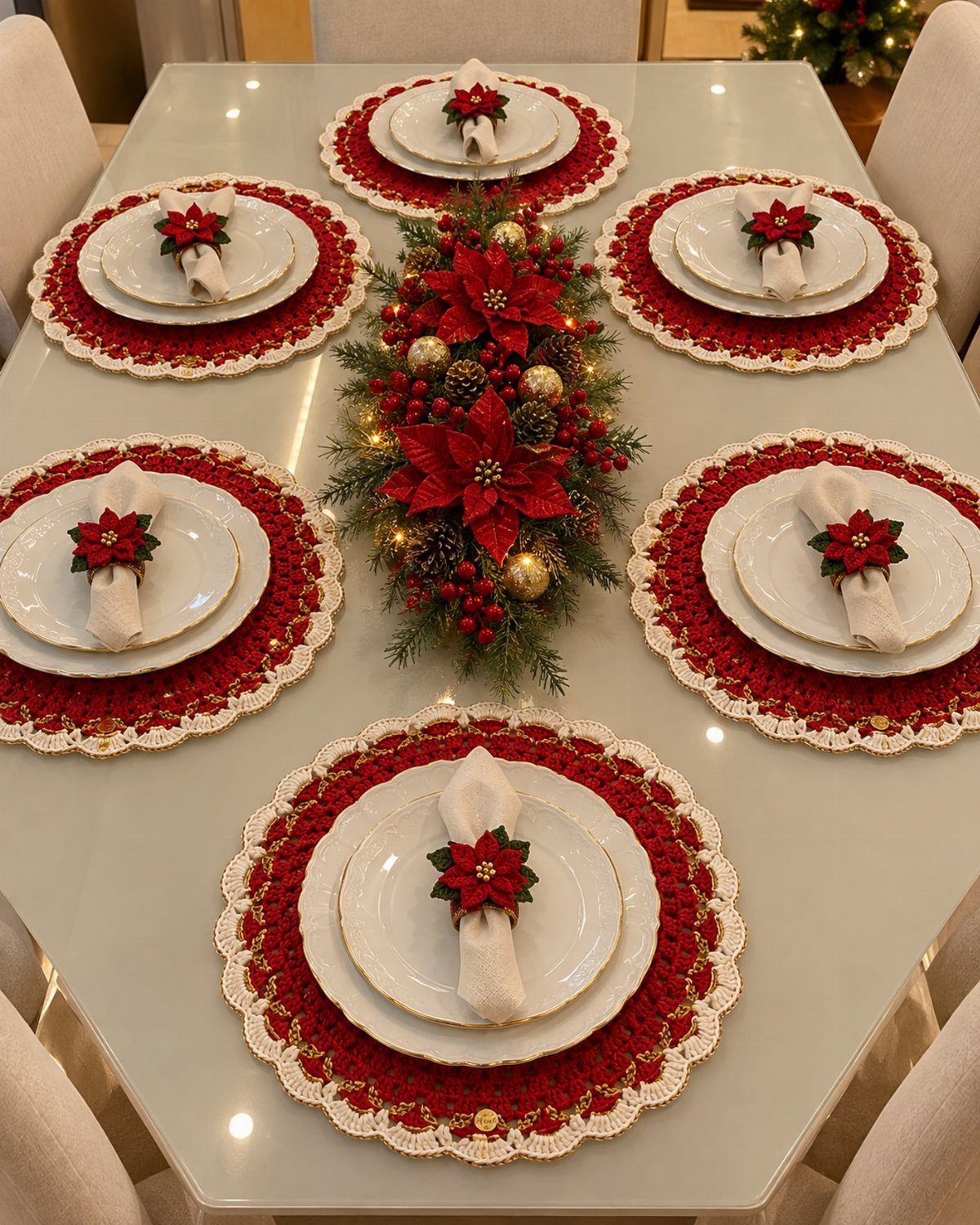 Christmas dining table setting with red placemats and a long floral centerpiece.