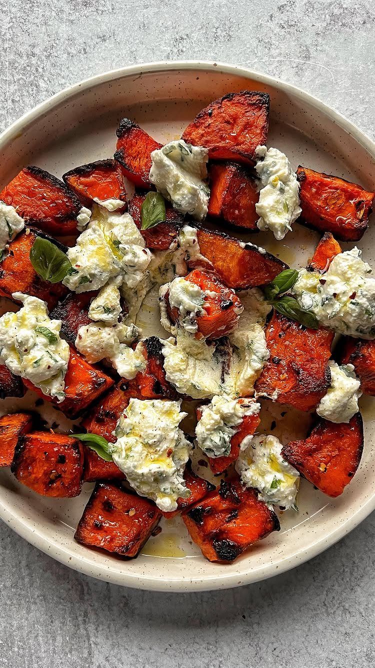 Roasted orange squash topped with dollops of herbed ricotta and fresh basil leaves.