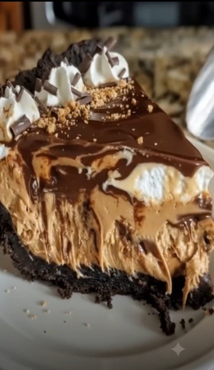 Peanut butter cream pie slice with chocolate ganache and whipped cream on white plate
