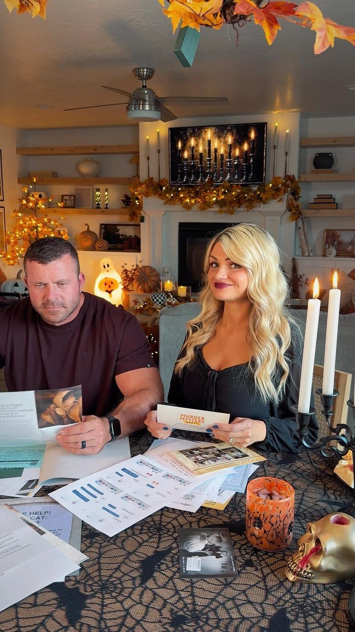 Man and woman playing a murder mystery game with clues and spooky decorations.