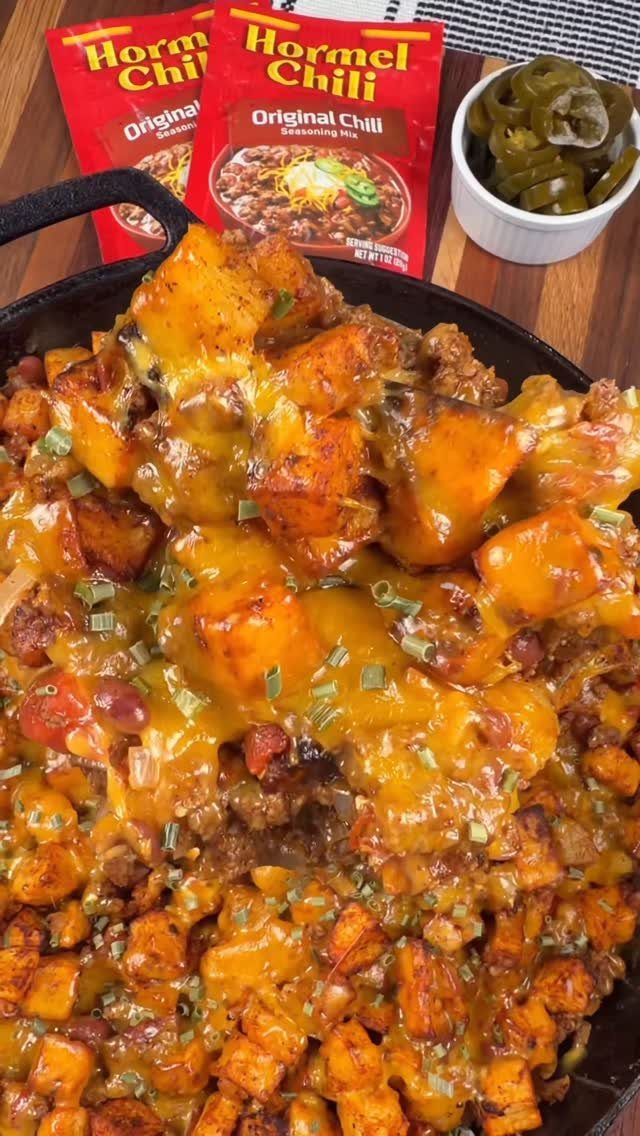 Sweet potato and ground beef skillet with melted cheese and green onions.