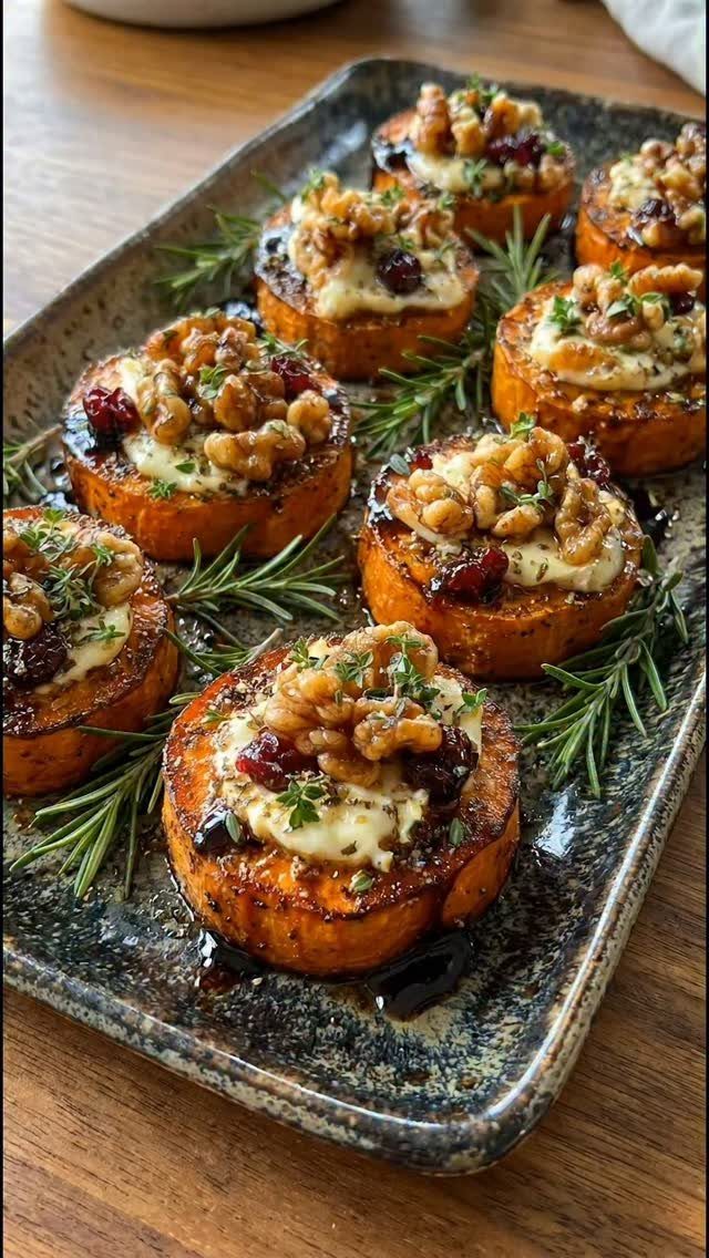 Roasted sweet potato rounds topped with goat cheese, walnuts, and dried cranberries.