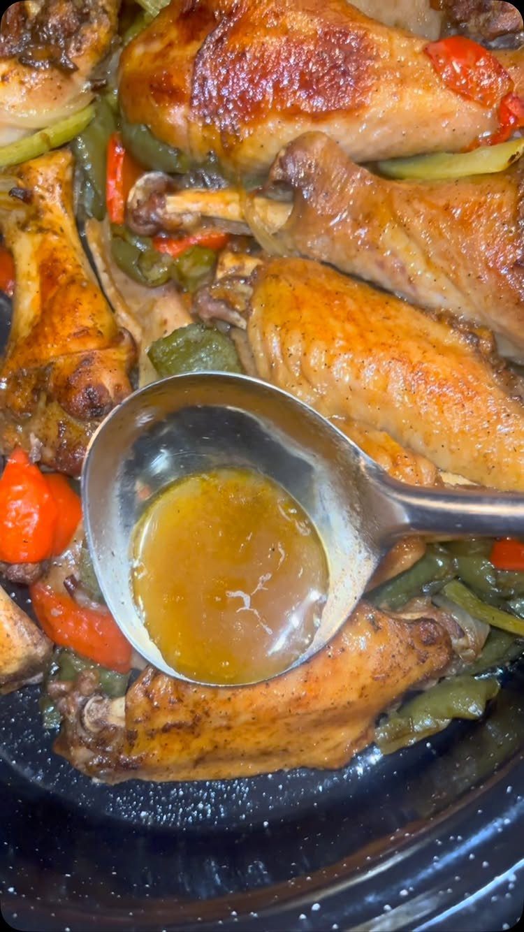Roasted turkey legs with bell peppers and gravy in a slow cooker.