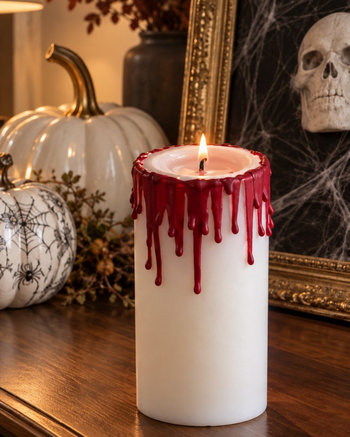 White pillar candle with red blood-like wax drips on a wooden table
