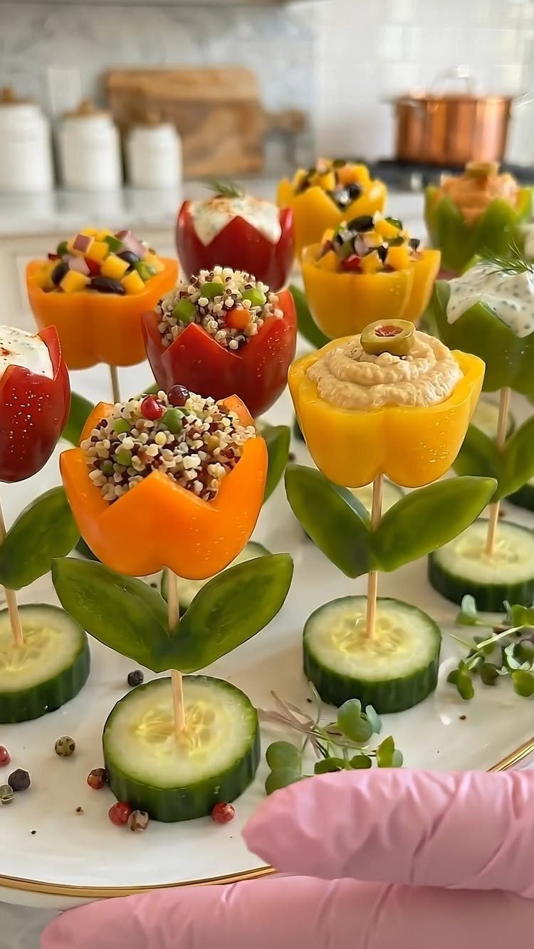 Mini bell pepper flower appetizers filled with salads on cucumber slice bases