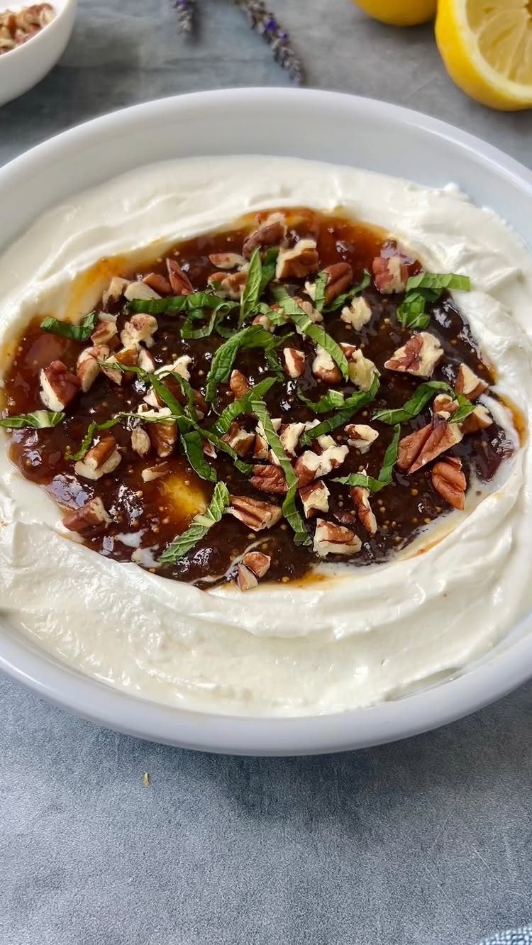 Whipped goat cheese dip topped with fig jam, pecans, and fresh mint leaves.