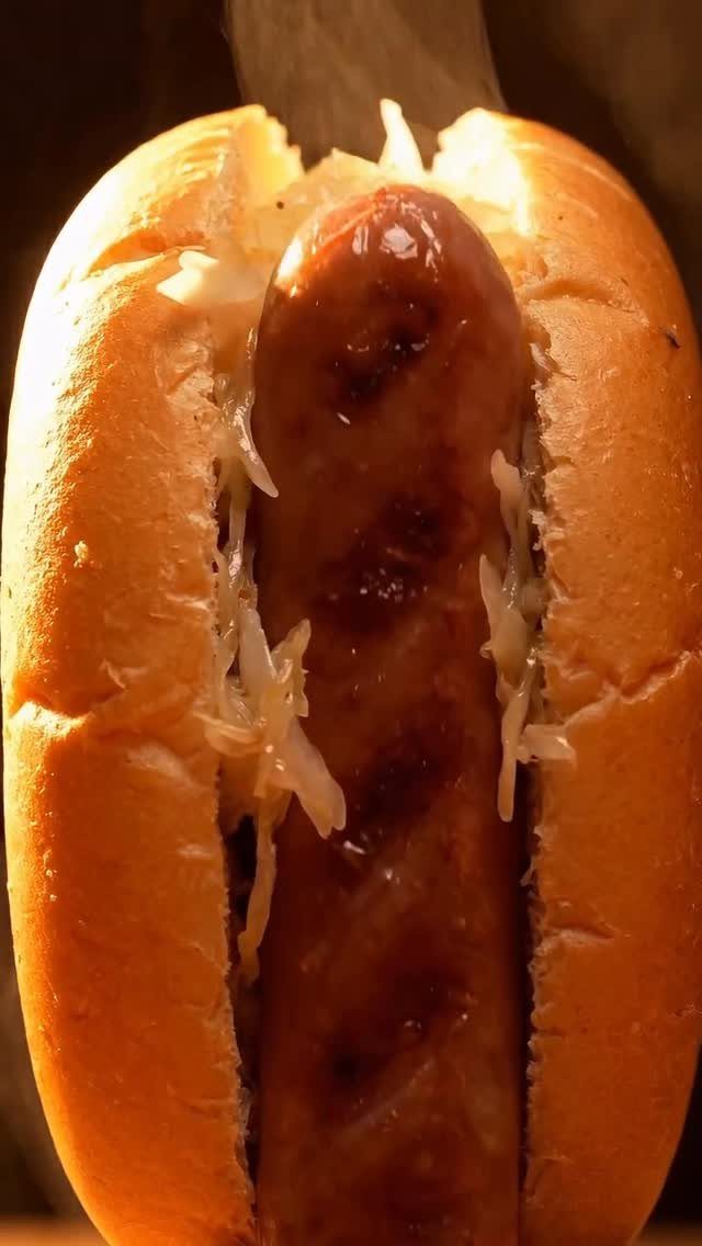 Grilled hot dog in a toasted bun topped with shredded white cabbage.