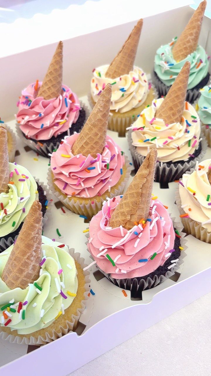 Cupcakes with colorful frosting and inverted cones designed to look like dropped ice cream.