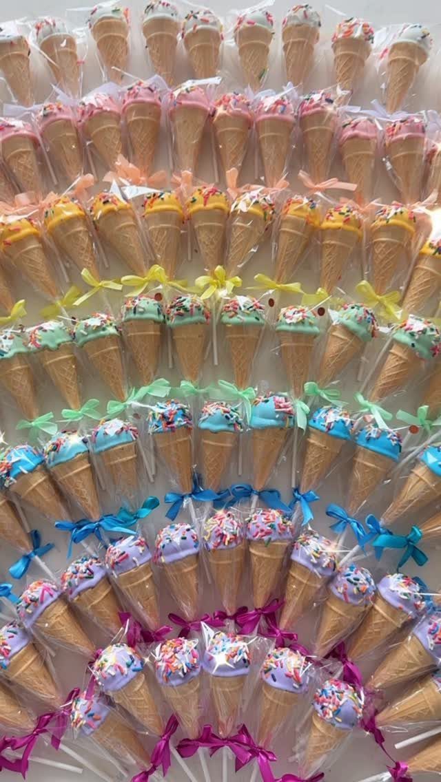 Colorful ice cream cone treats wrapped in plastic bags with ribbons as party favors.