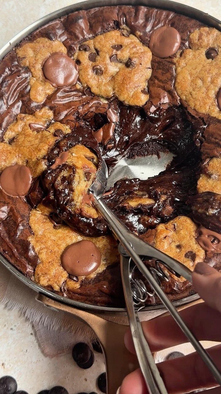 Chocolate chip cookie skillet with melted chocolate and a spoon scooping the center.