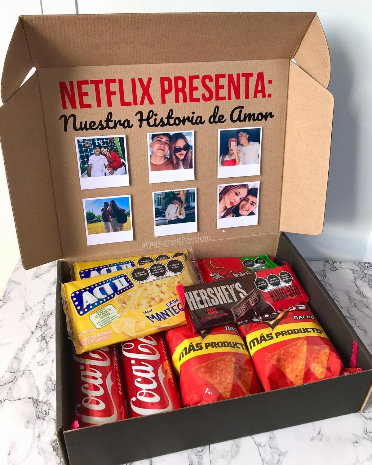 Movie night gift box filled with snacks and personal photos on the lid