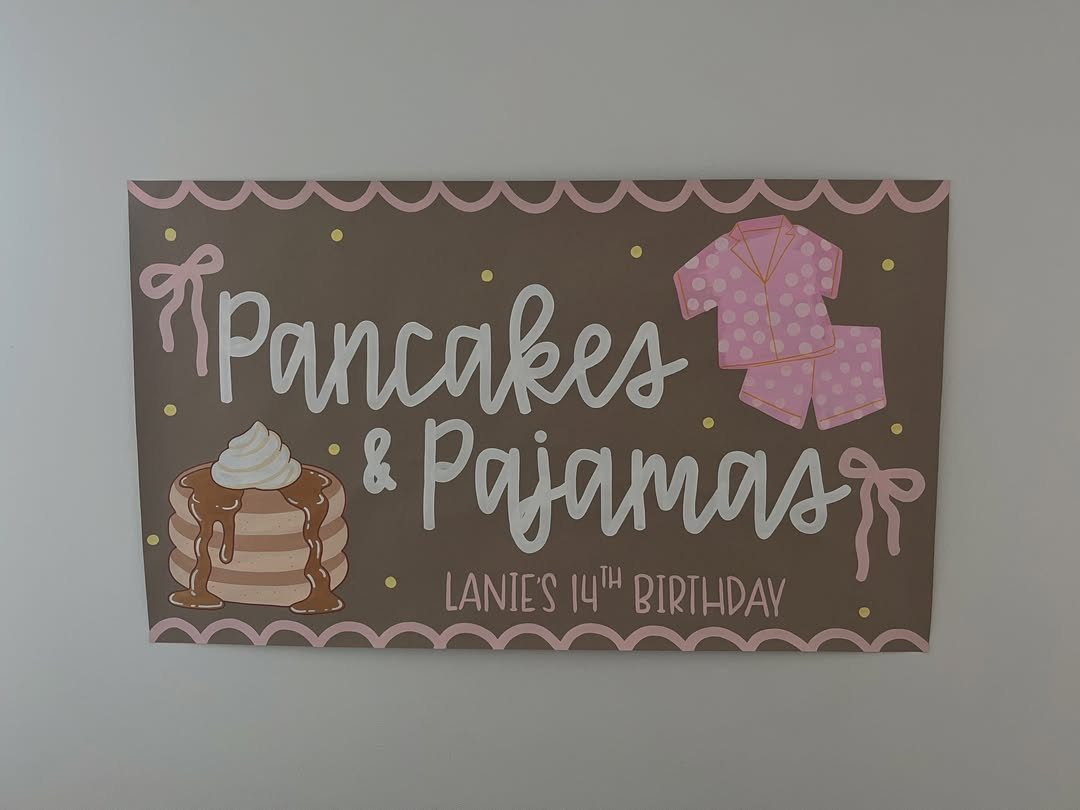 Pancakes and Pajamas birthday sign with pancake and pajama illustrations on brown background