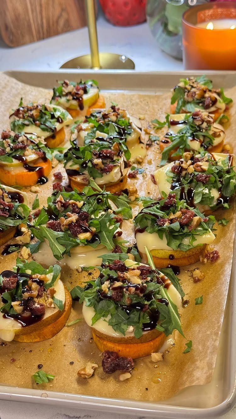 Sweet potato rounds topped with melted cheese, arugula, cranberries, and balsamic glaze.
