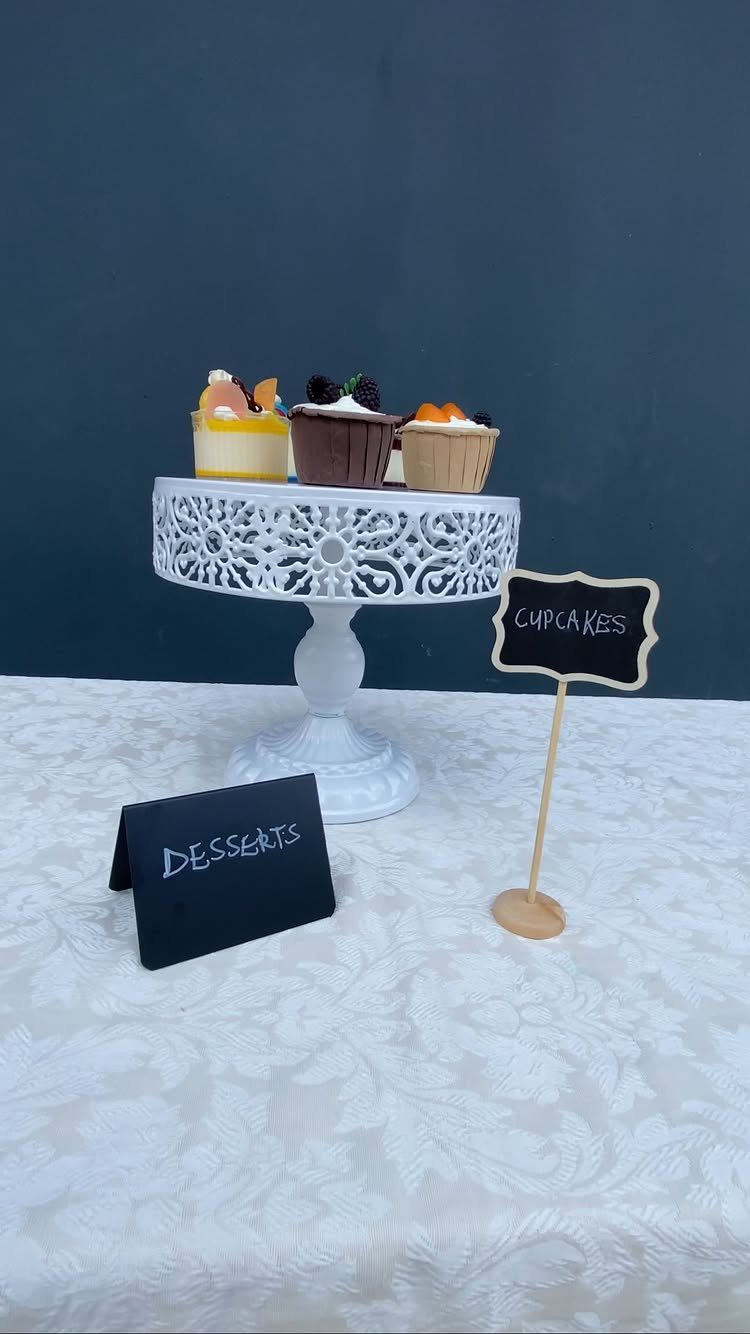 Cupcakes on a white cake stand with black dessert and cupcake food labels.