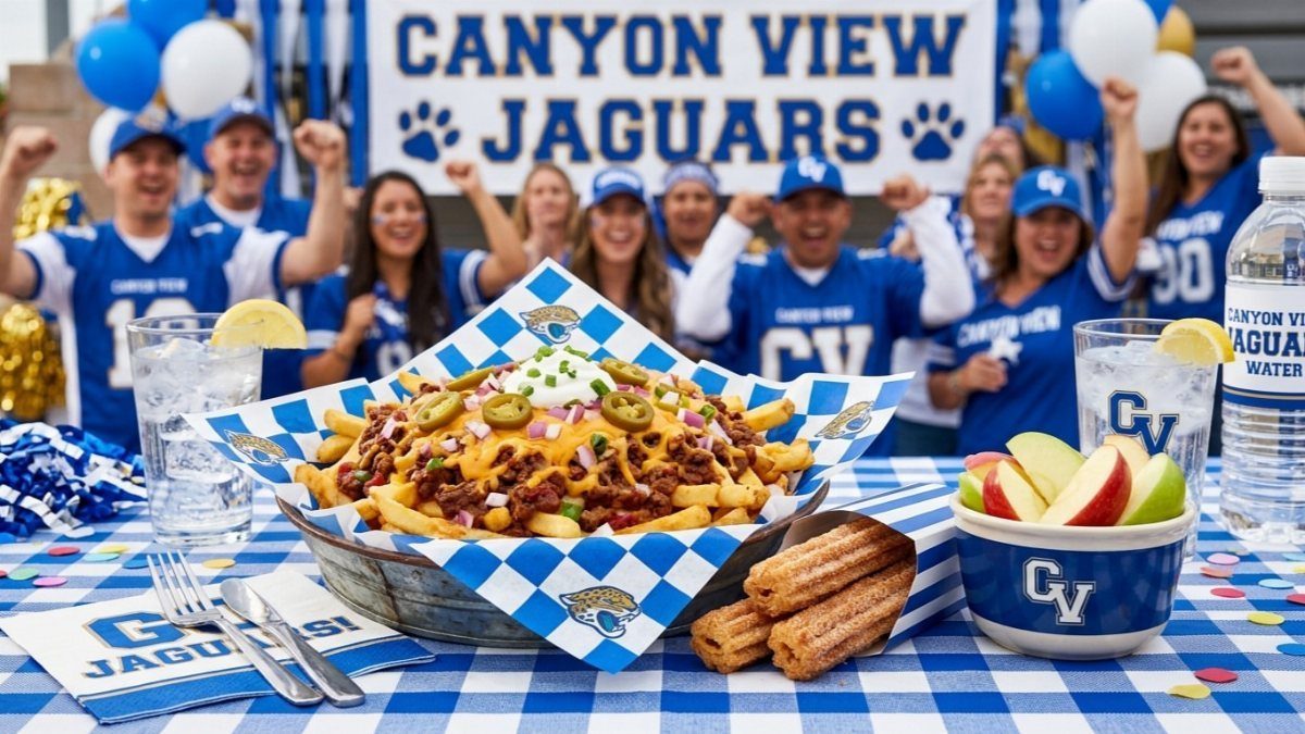 Loaded french fries with toppings in a checkered basket on a blue tablecloth.