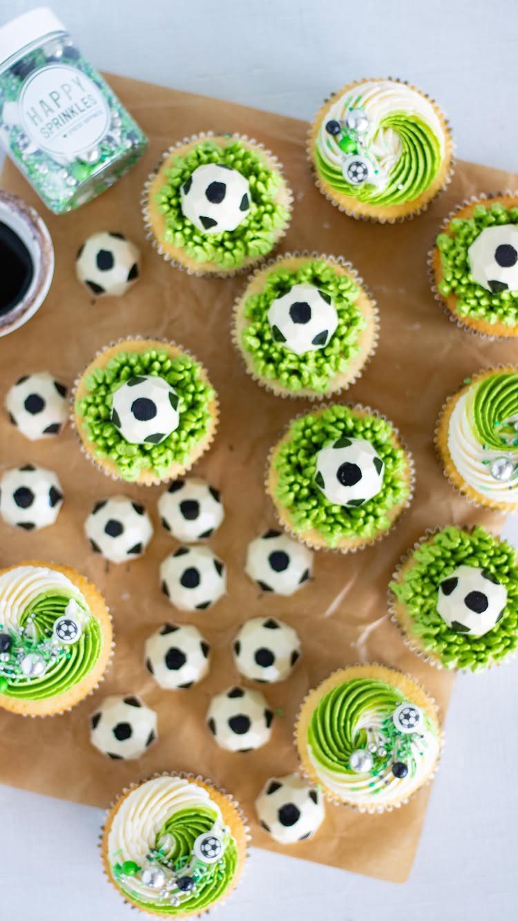 Soccer themed cupcakes and cake pops with green frosting and soccer ball designs.