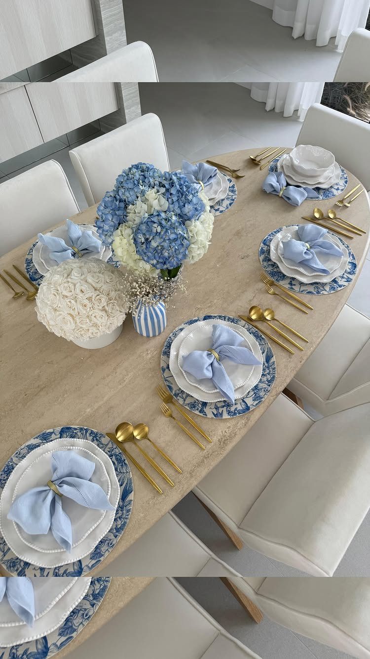 Blue and white patterned china plates with gold cutlery and blue hydrangea centerpiece.