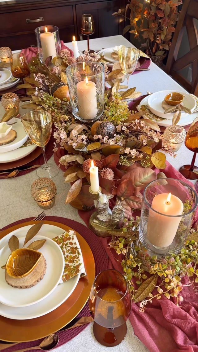 Elegant Thanksgiving table with burgundy runner, gold chargers, and autumn floral centerpiece.