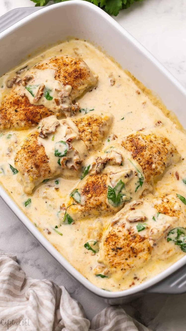 Seared chicken breasts in a creamy Tuscan sauce with spinach and mushrooms.